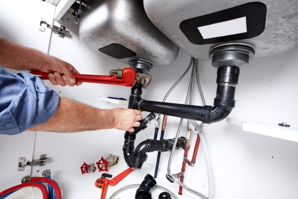 Jupiter Plumbing Pros fixing under sink plumbing and drain pipes