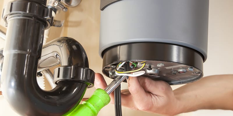 Jupiter, Florida plumber servicing water heater pipe connection