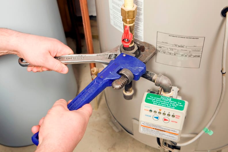 Plumber repairing a water heater valve in Jupiter